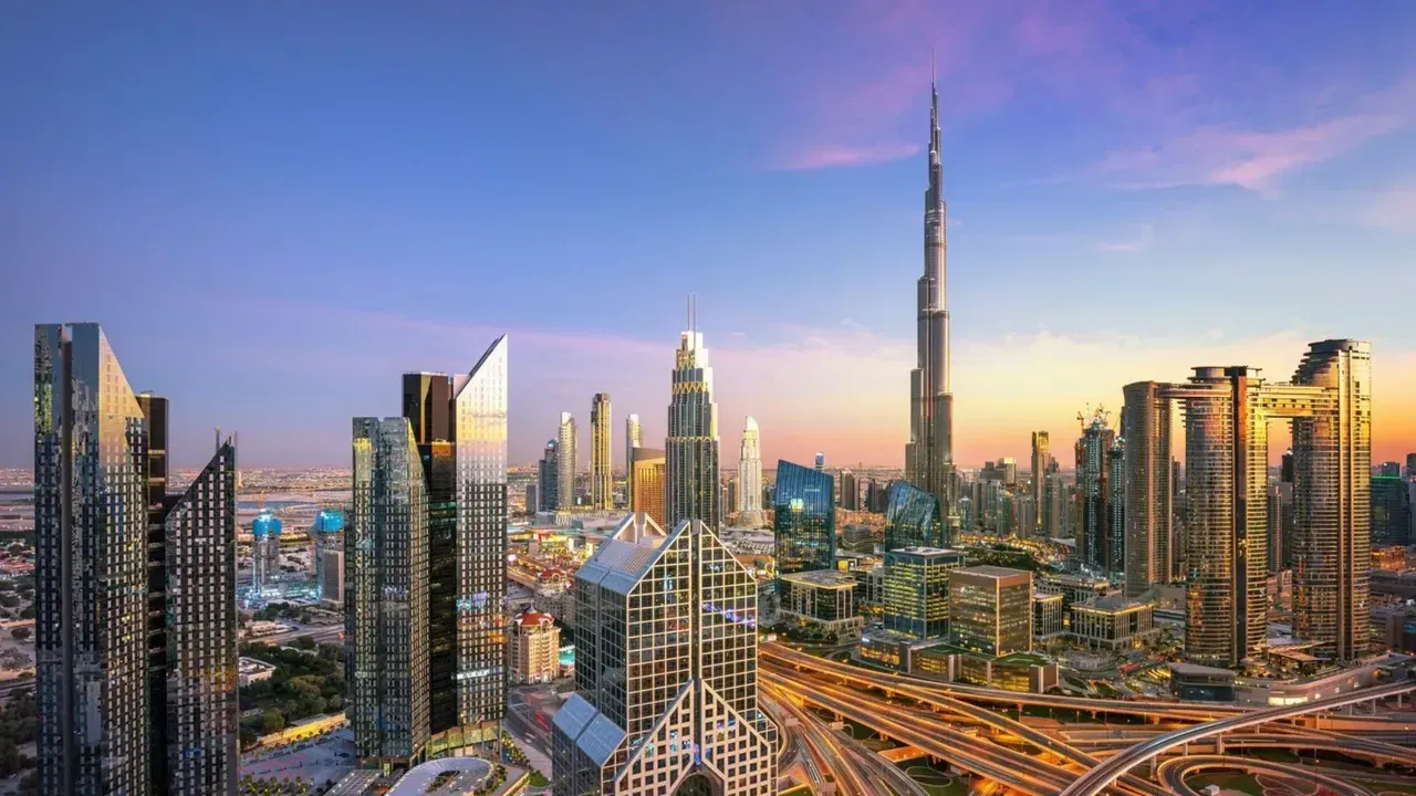 Burj Khalifa and Dubai skyline at sunset with modern skyscrapers, vibrant cityscape, and bustling highways in an urban panorama.