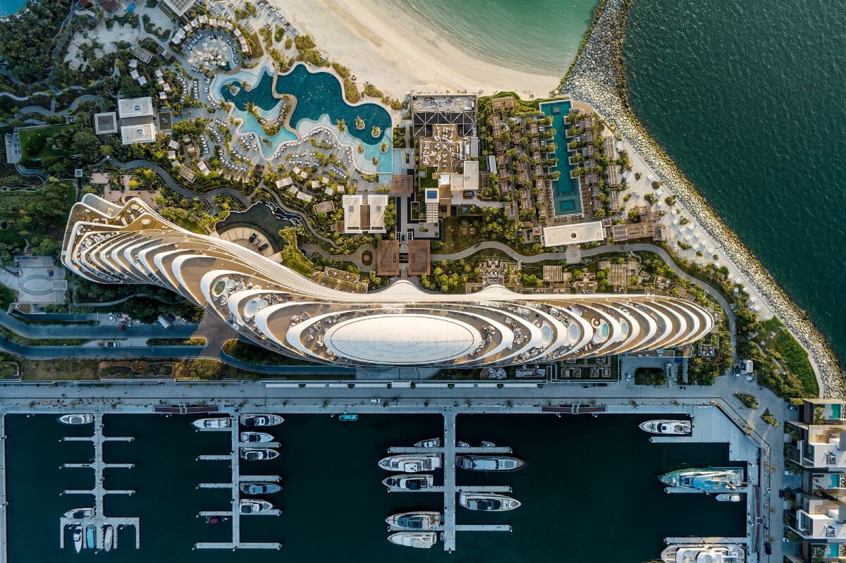 Top-down view of Jumeirah Marsa Al Arab in Dubai with marina, beach, and modern design for a 2025 luxury getaway.