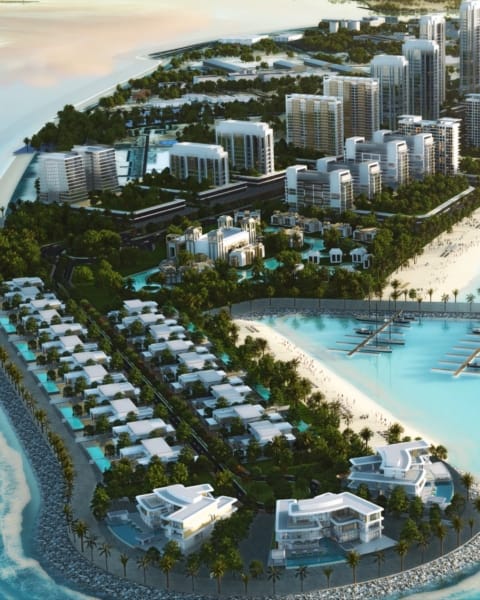 Architectural render of Downtown Umm Al Quwain’s luxury waterfront residences with marina and modern towers.