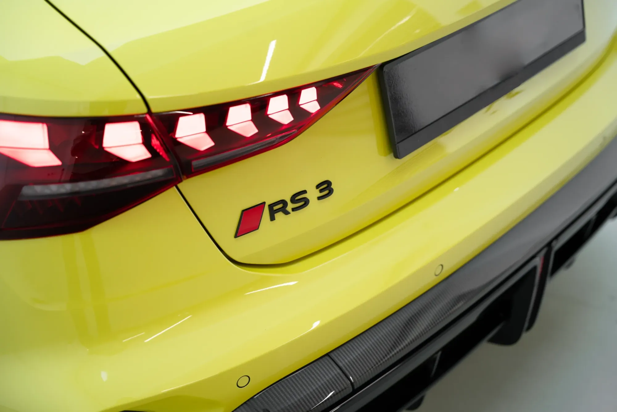 Close-Up of 2024 Yellow Audi RS3 Sportback Badge and LED Taillight – High-Performance Hatchback in Dubai
