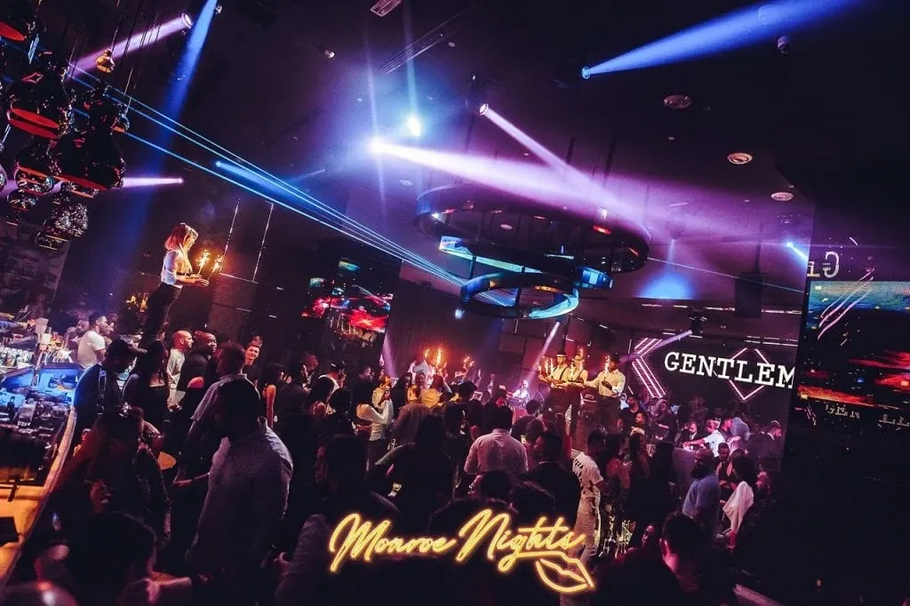 Billionaire Dubai nightclub Monsoon Nights event with dancers, lights, and upscale crowd enjoying luxury nightlife.