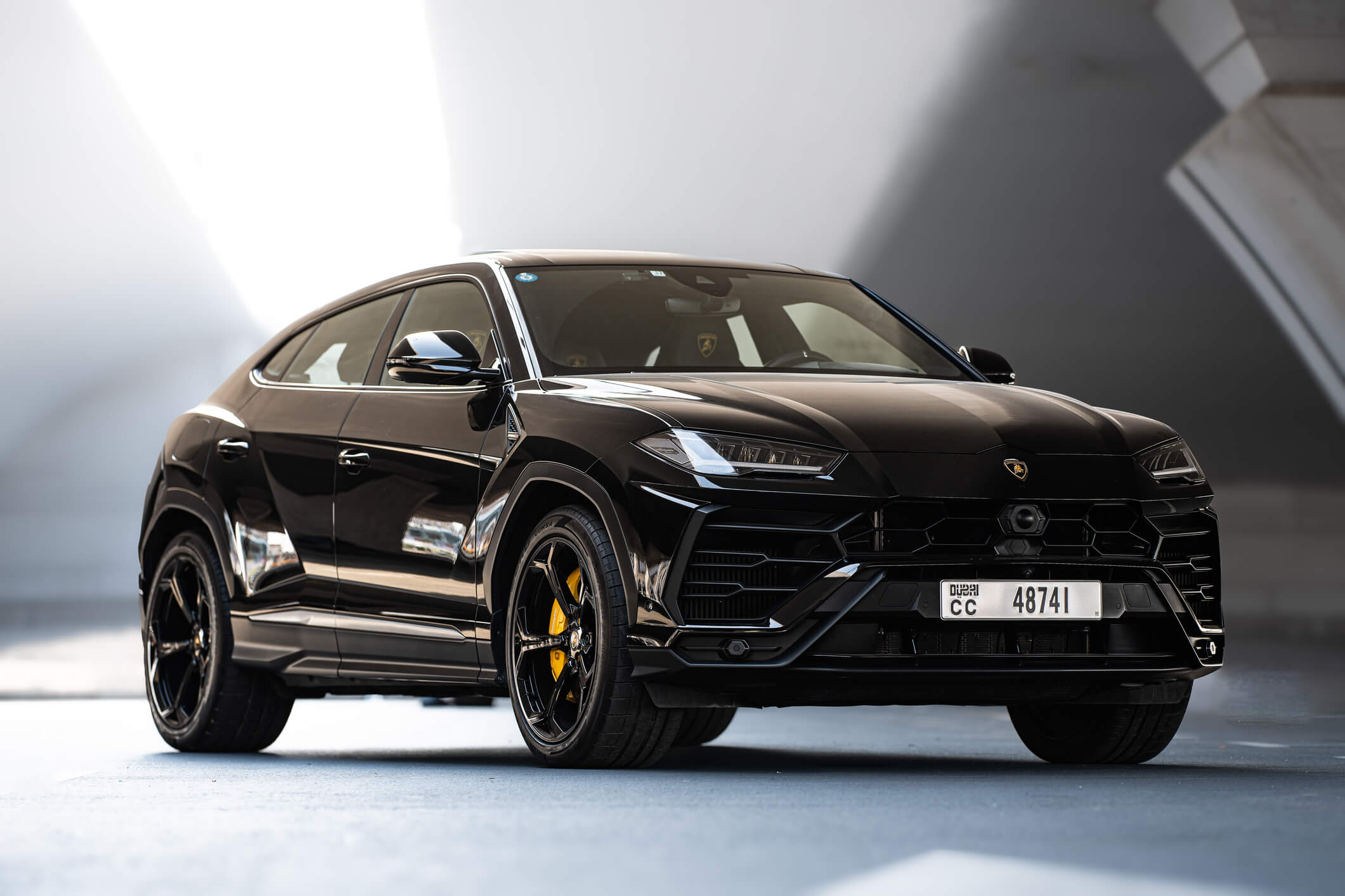 Black Lamborghini Urus SUV with yellow calipers in Dubai – premium rental available from Solid Cars with 24/7 service