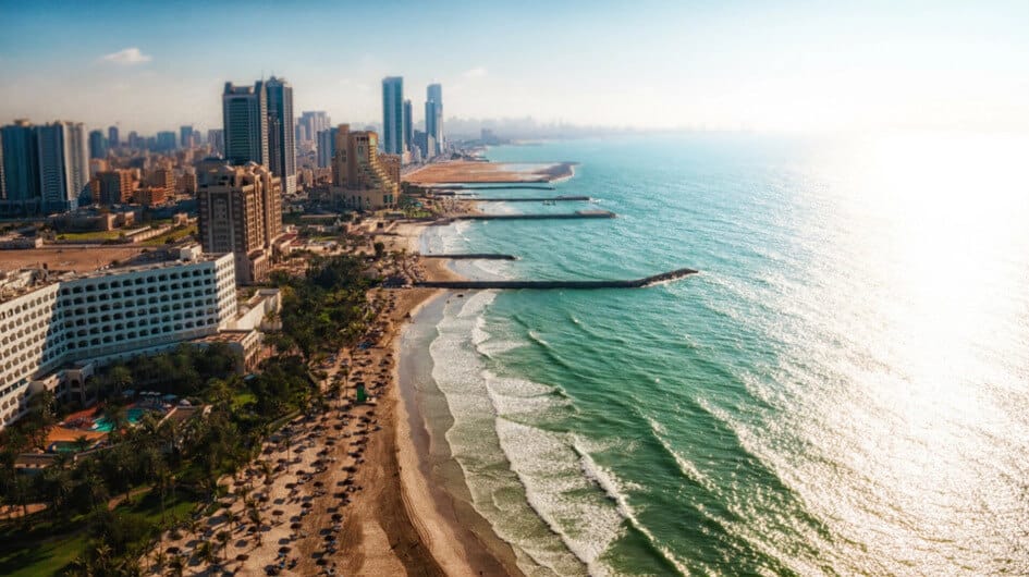 Ajman beachfront with modern skyline and turquoise waves — a serene coastal escape in the UAE with urban charm.