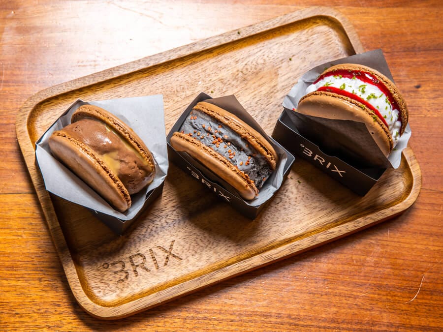 BRIX Dubai macaron ice cream sandwiches in three flavours served on a wooden tray
