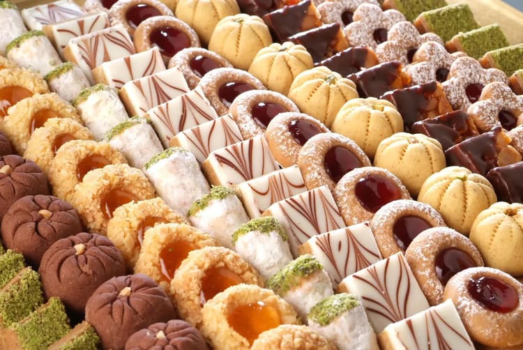 Assorted Middle Eastern and French pastries from Dubai’s best dessert cafés arranged in rows