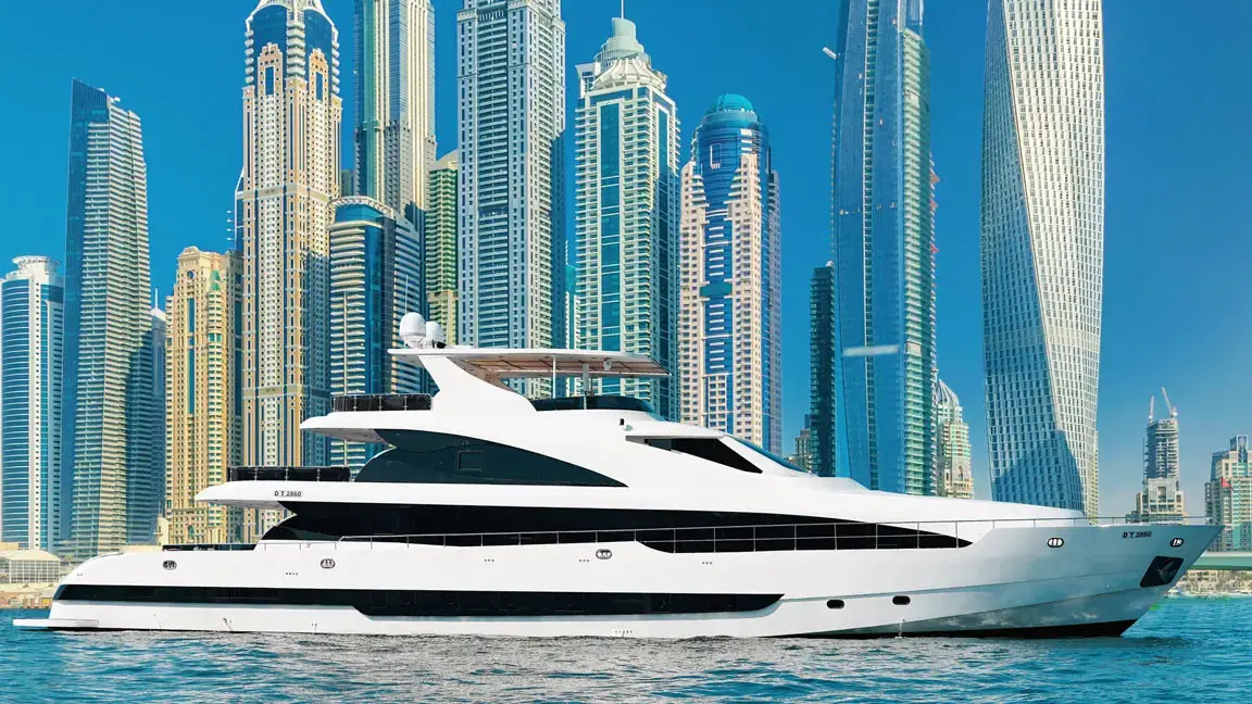 Luxury white yacht cruising in Dubai Marina with iconic skyscrapers and twisted Cayan Tower in the background