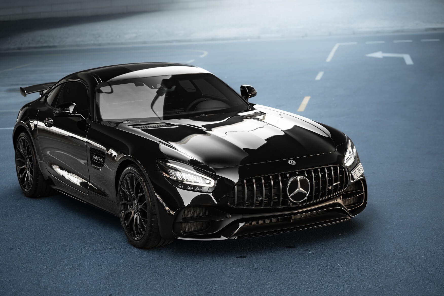 Front angle view of black Mercedes-AMG GT Night Edition parked in Dubai, showcasing aggressive grille and luxury styling