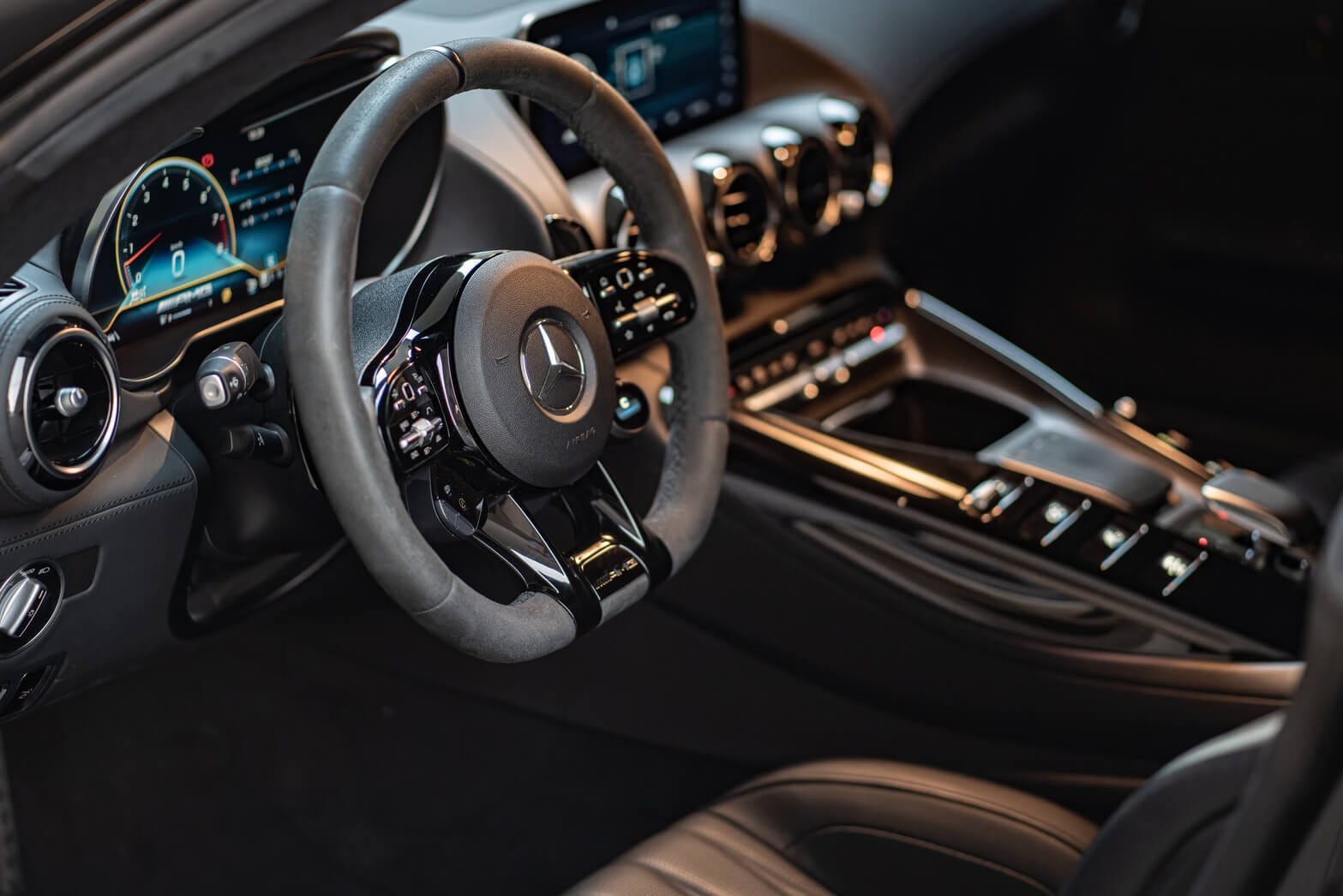 Interior view of Mercedes-AMG GT Night Edition showing AMG steering wheel and digital dashboard for luxury rental in Dubai