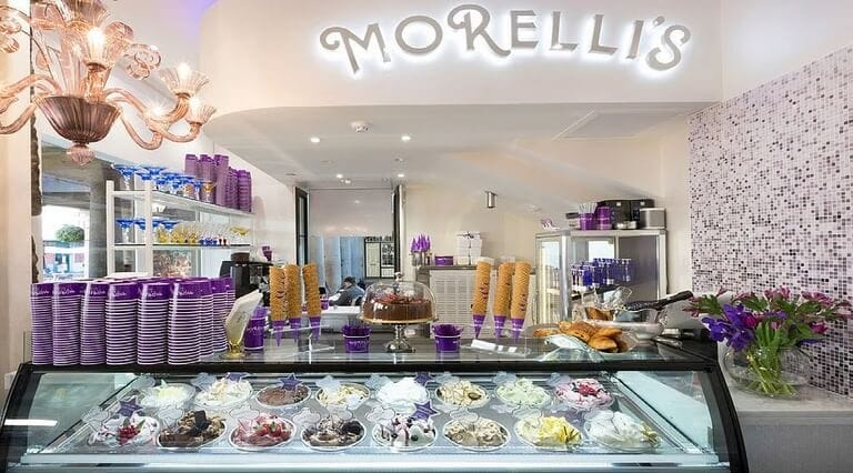 Morelli’s Gelato Dubai ice cream parlour interior with gelato counter, cones, and signature purple decor