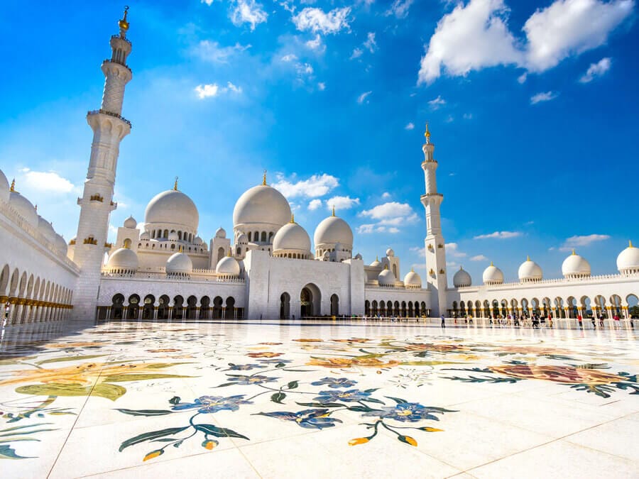 Sheikh Zayed Grand Mosque in Abu Dhabi, UAE — iconic white marble architecture with floral courtyard and minarets.