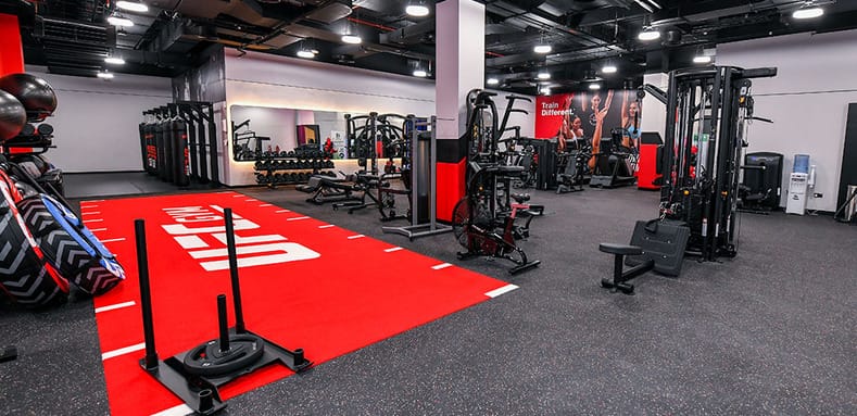 UFC Gym Dubai functional training area with sled track, strength machines, and cardio equipment in 2025.