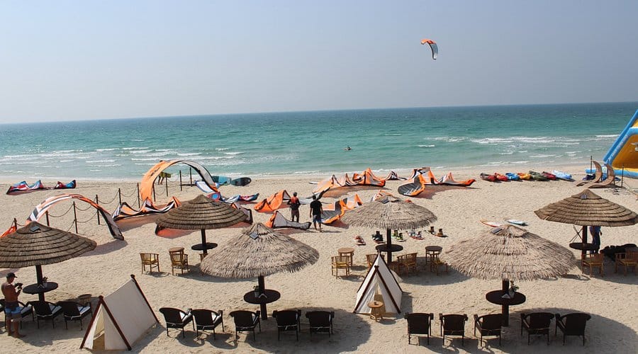 Kitesurfing beach in Umm Al Quwain, UAE — a laid-back coastal retreat with water sports, umbrellas, and ocean views.