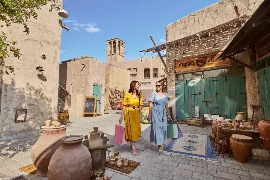 Two women exploring Al Seef at Dubai Creek, a heritage-style district offering free cultural strolls in 2025