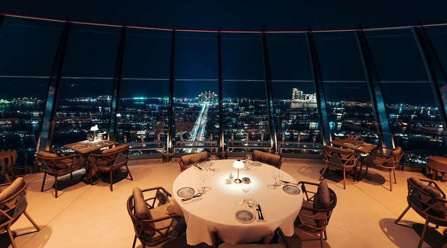 CouCou Dubai rooftop dining with panoramic night views of Palm Jumeirah and illuminated cityscape