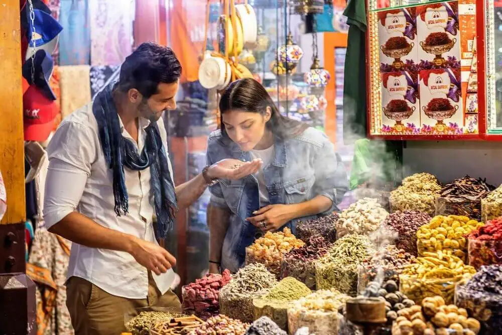 Tourists exploring aromatic spices at Dubai’s traditional Spice Souk, a free cultural experience in 2025