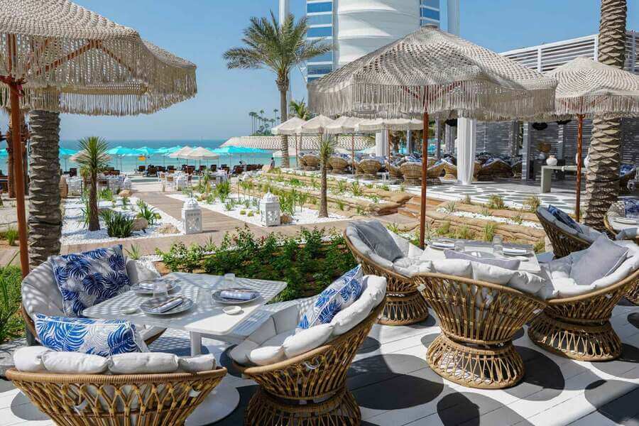 Boho-chic outdoor seating with ocean view at Summersalt Beach Club in Jumeirah Al Naseem, Dubai