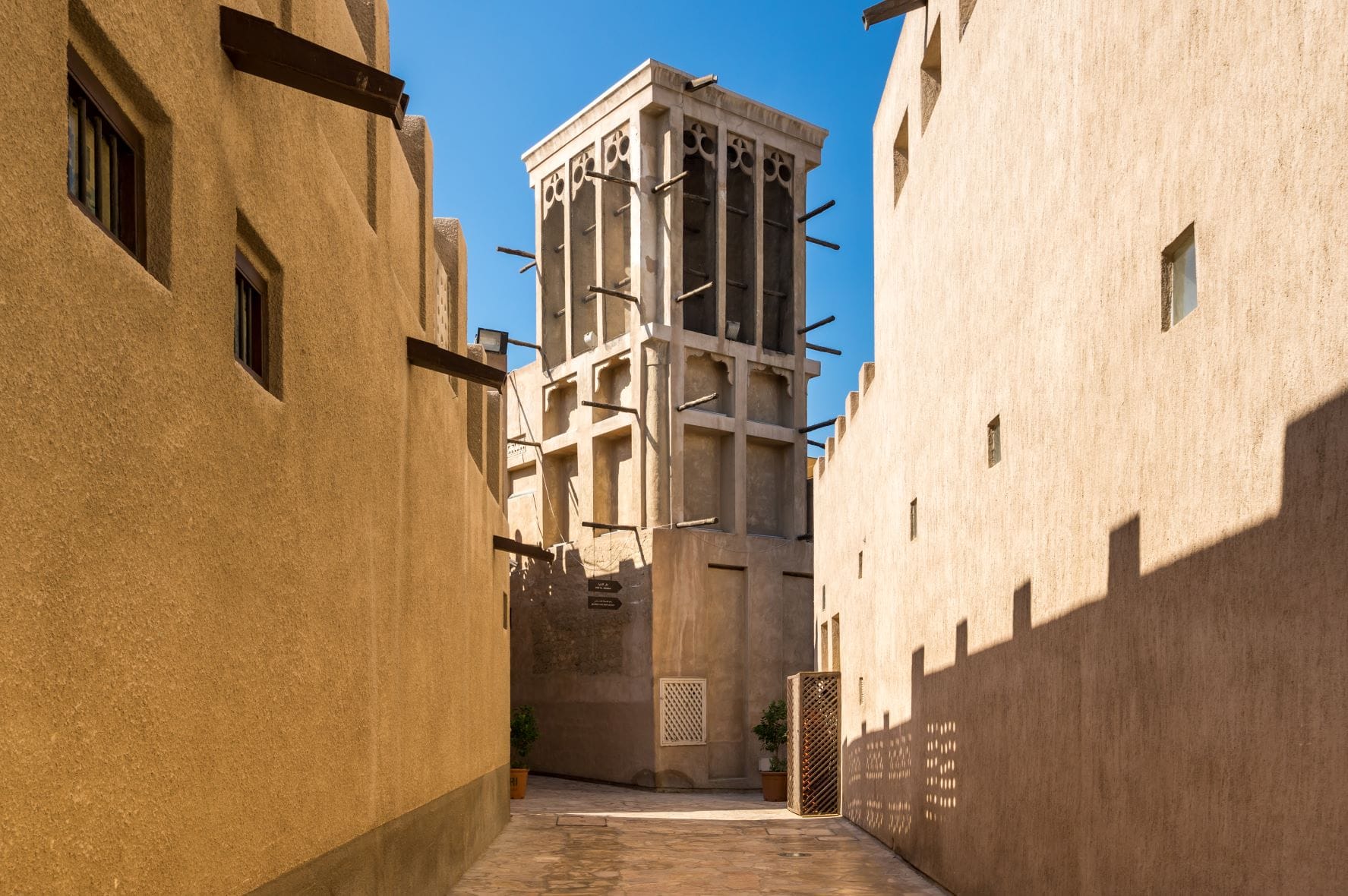 Traditional wind tower and narrow pedestrian lane in Al Fahidi Historical Neighbourhood Dubai