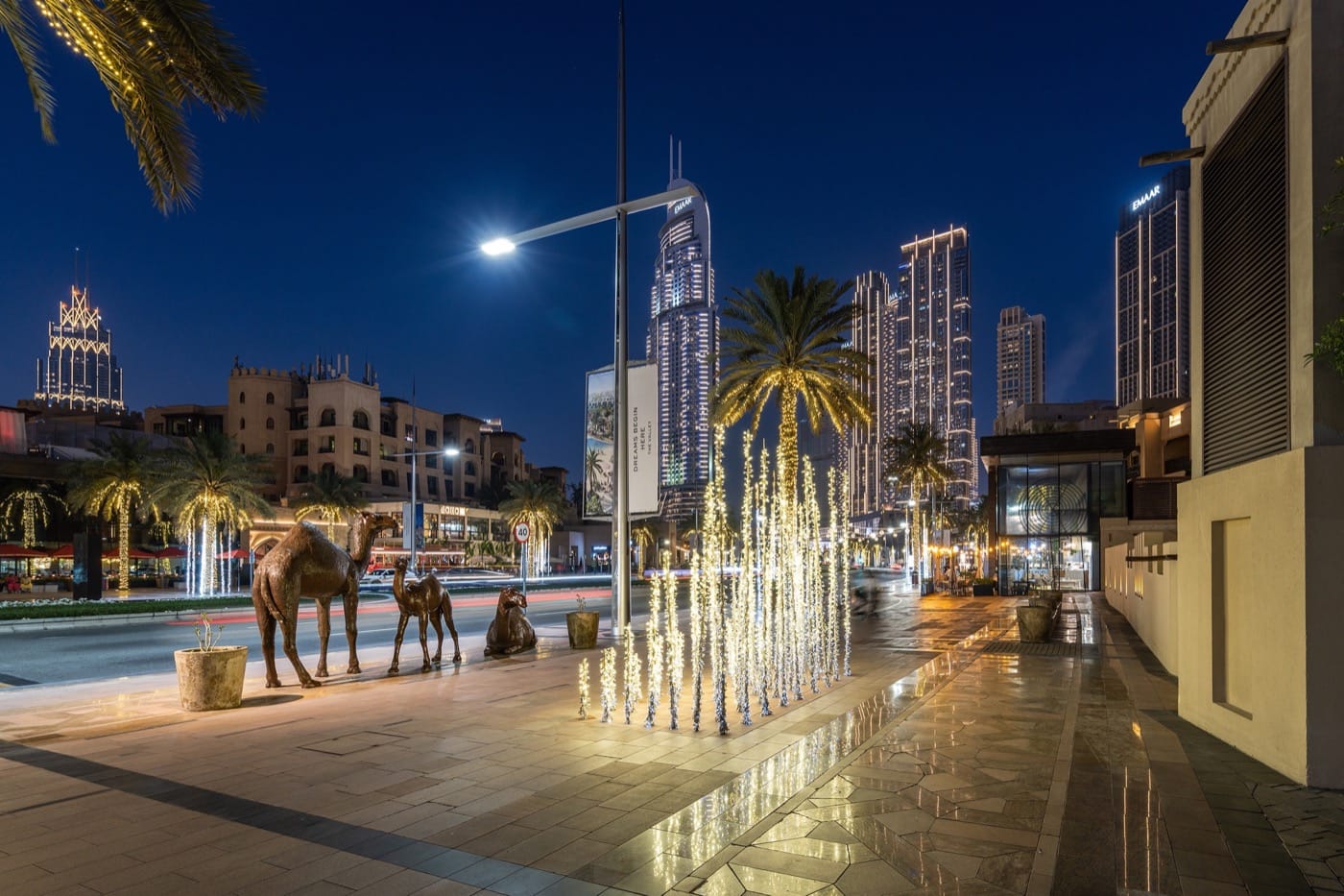 Mohammed Bin Rashid Boulevard in Downtown Dubai at night with lights, sculptures and wide walkway