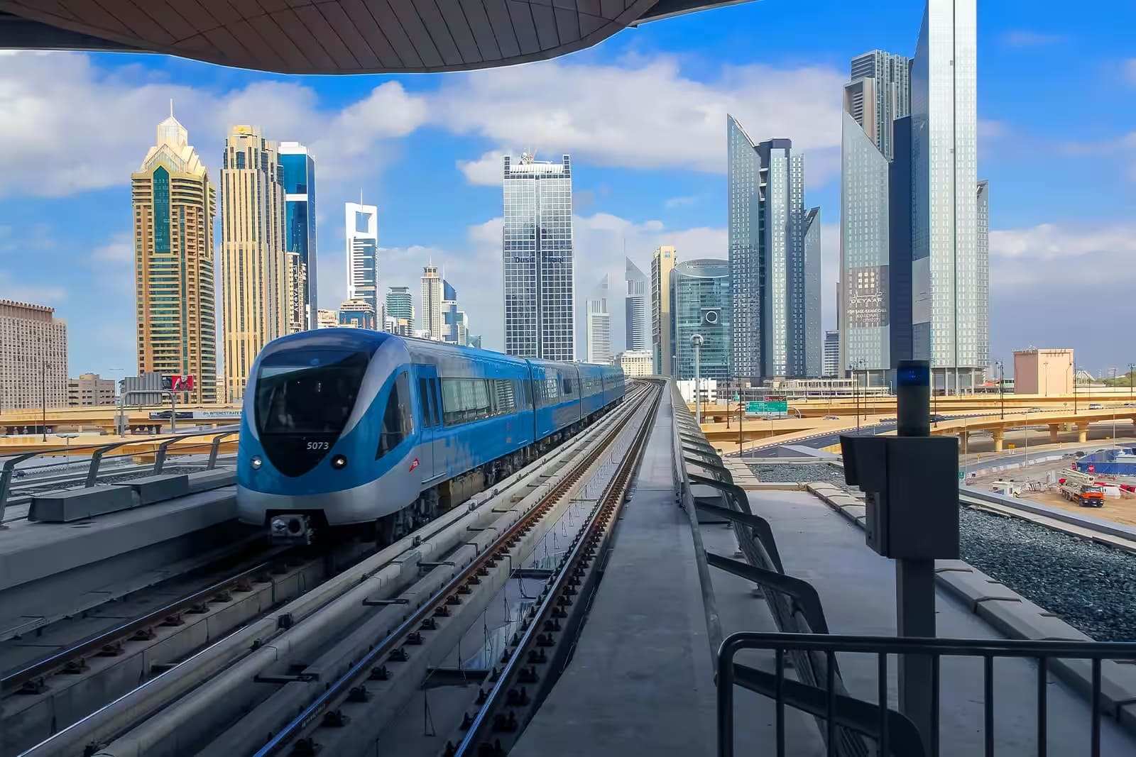Dubai Metro train with city skyline showing public transport Wi-Fi connectivity.