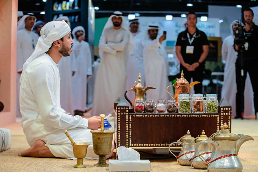 Emirati man preparing traditional Gahwa coffee during a cultural hospitality ceremony in the UAE.