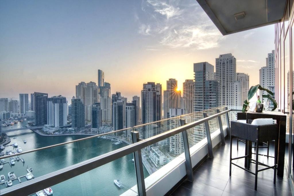Luxury Dubai Marina apartment balcony with sunset skyline and waterfront views in 2025