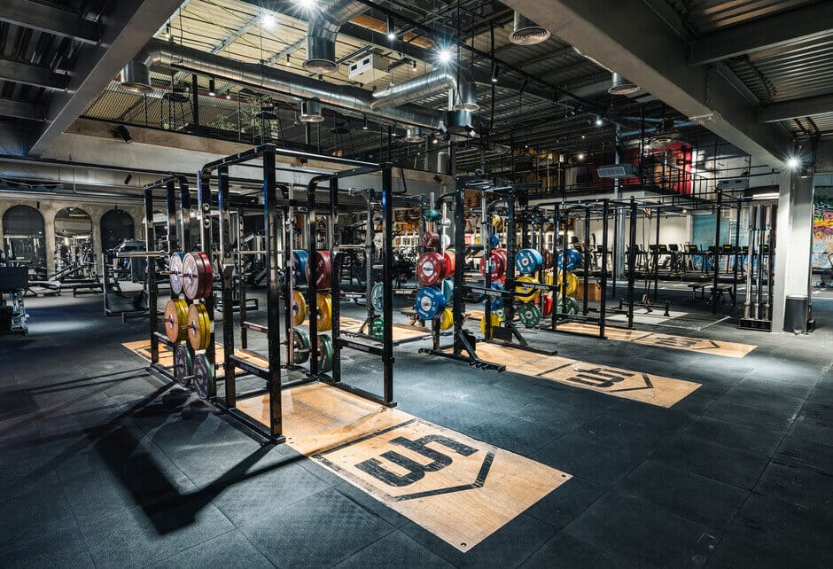 CrossFit and strength training zone at The Warehouse Gym Dubai with weightlifting platforms and bumper plates in 2025.