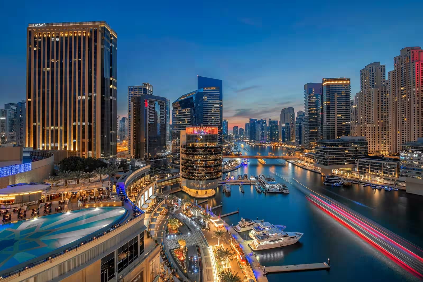 Dubai Marina skyline at night with yachts and lights, showing safe and vibrant areas for solo travelers in 2025
