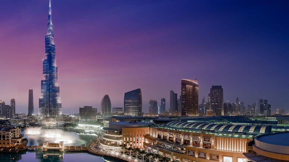Downtown Dubai skyline at night with Burj Khalifa, Dubai Mall and Dubai Fountain illuminated