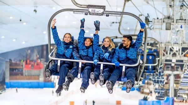 Group enjoying chairlift ride at Ski Dubai, the indoor snow park at Mall of the Emirates.