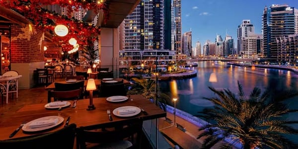 Romantic waterfront dining at Dubai Marina with stunning evening skyline and canal views