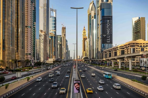 Modern highway connecting Dubai and Abu Dhabi surrounded by skyscrapers on Sheikh Zayed Road during daylight traffic
