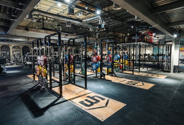 CrossFit and strength training zone at The Warehouse Gym Dubai with weightlifting platforms and bumper plates in 2025.