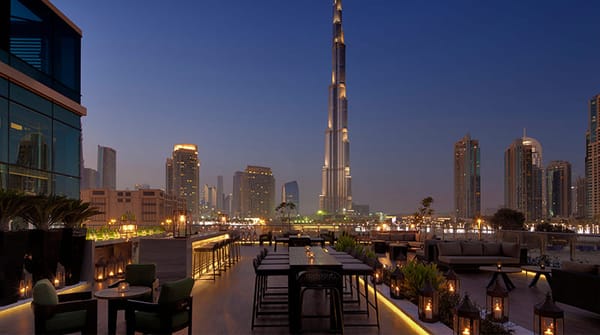 Treehouse rooftop lounge in Dubai with Burj Khalifa views, elegant outdoor seating, and ambient evening lighting