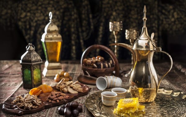 Traditional Emirati coffee (Gahwa) served with dates, nuts, and sweets during a cultural gathering.