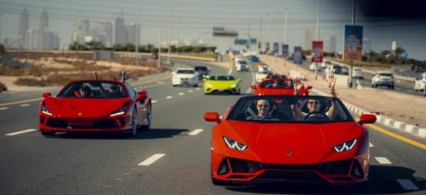 Convoy of Lamborghini and Ferrari supercars driving in Dubai for luxury car rental experience