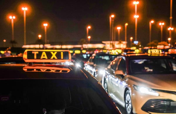 Dubai taxi at night with bright taxi sign for tourists in 2025