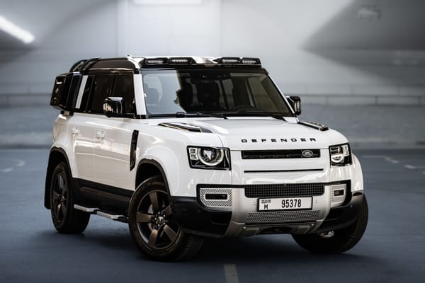 White Land Rover Defender luxury SUV rental in Dubai parked in modern tunnel setting